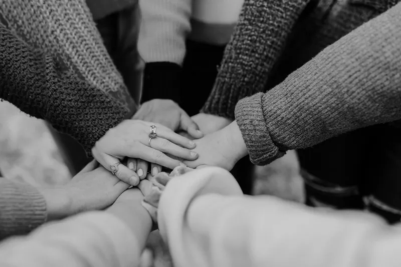 A group of hands laid over one another